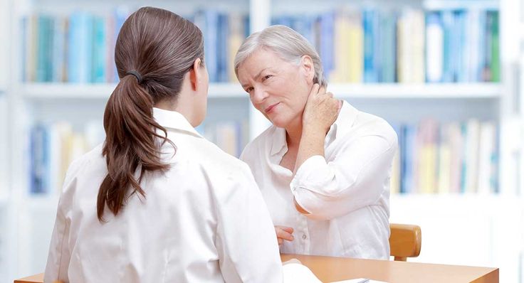 Mujer acudiendo al medico por un dolor muscular